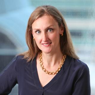 A person wearing a gold necklace
Description automatically generated