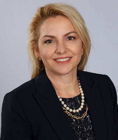 A person smiling for the camera
Description automatically generated