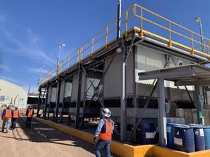 A group of people walking next to a building

Description automatically generated