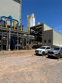 A truck parked outside of a factory

Description automatically generated